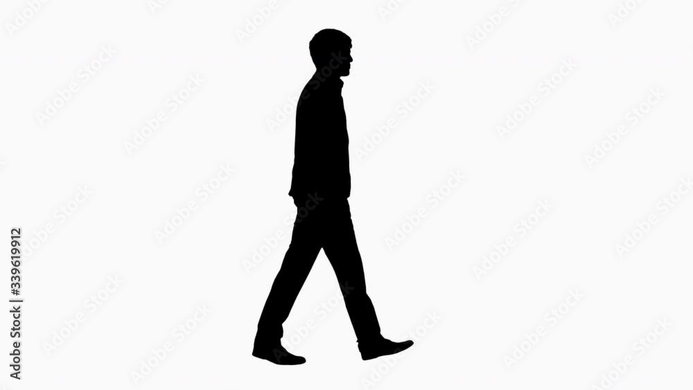 Silhouette Handsome business man walking with his hands in pockets.