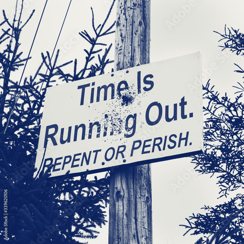 Religious repent or perish sign on telephone pole photo