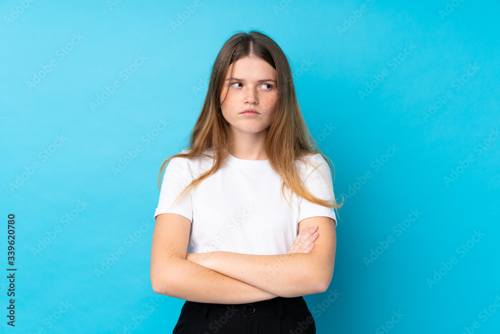 Ukrainian teenager girl over isolated blue background thinking an idea Ukrainian teenager girl over isolated blue background thinking an idea