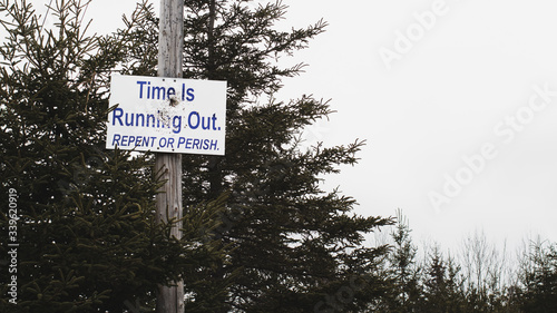 Religious repent or perish sign on telephone pole photo