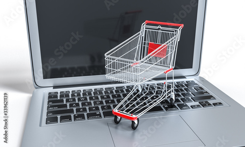 shopping cart on a notebook keyboard. online shopping and ecommerce