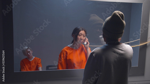 Prisoner talking to man in visit room. Medium shot