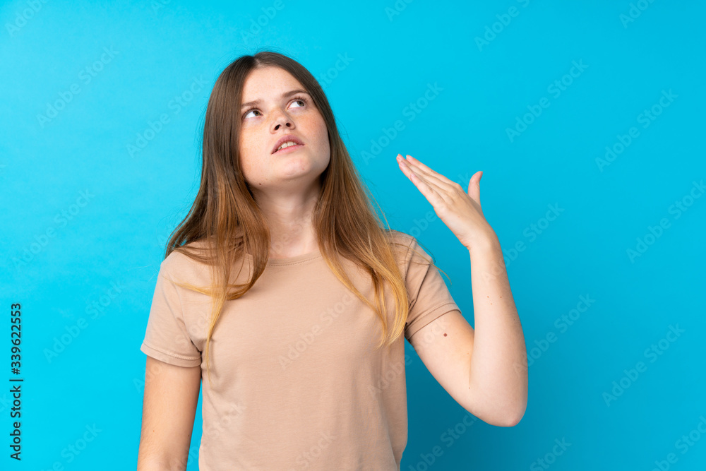 Ukrainian teenager girl over isolated blue background with tired and sick expression