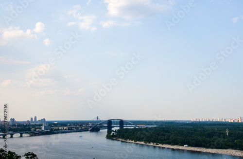 Panoramic view from new Pedestrian-Bicycle Bridge. Beautiful Dnipro River with bridges and residential houses at the background in the capital of Ukraine, Kyiv