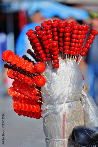 Street vendor's bicycle selling candied tanghulu-mountain hawthorns and mandarins. Jiayuguan-Gansu-China-0805 photo