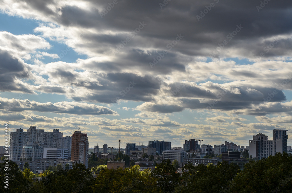 View of new buildings in residential areas surrounded by green trees and amazing blue sky with clouds in the capital of Ukraine Kyiv View of new buildings in residential areas surrounded by green trees and amazing blue sky with clouds in the capital of Ukraine Kyiv