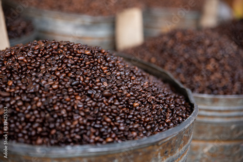 Heap of coffee bean with blurred background of coffee barrels, macro © Joe McUbed