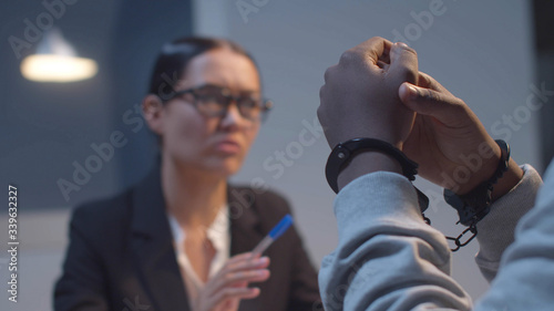 The prisoner listens to the lawyer. Close up
