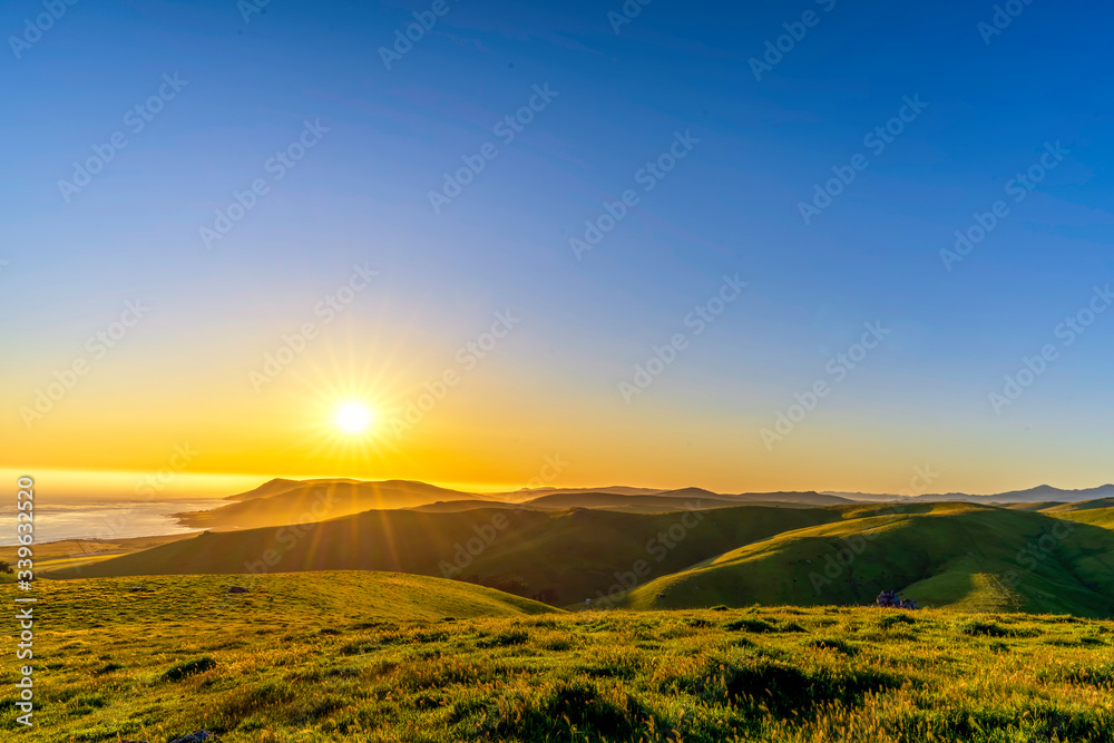 Sunset over Mountains, Ocean, grass, pasture Sunset over Mountains, Ocean, grass, pasture