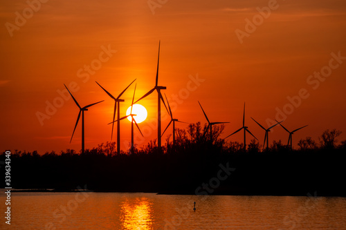 Moerdijk Netherlands, sunset winth windmills by the lake Vokerak river in Holland windmill energy sunset  photo