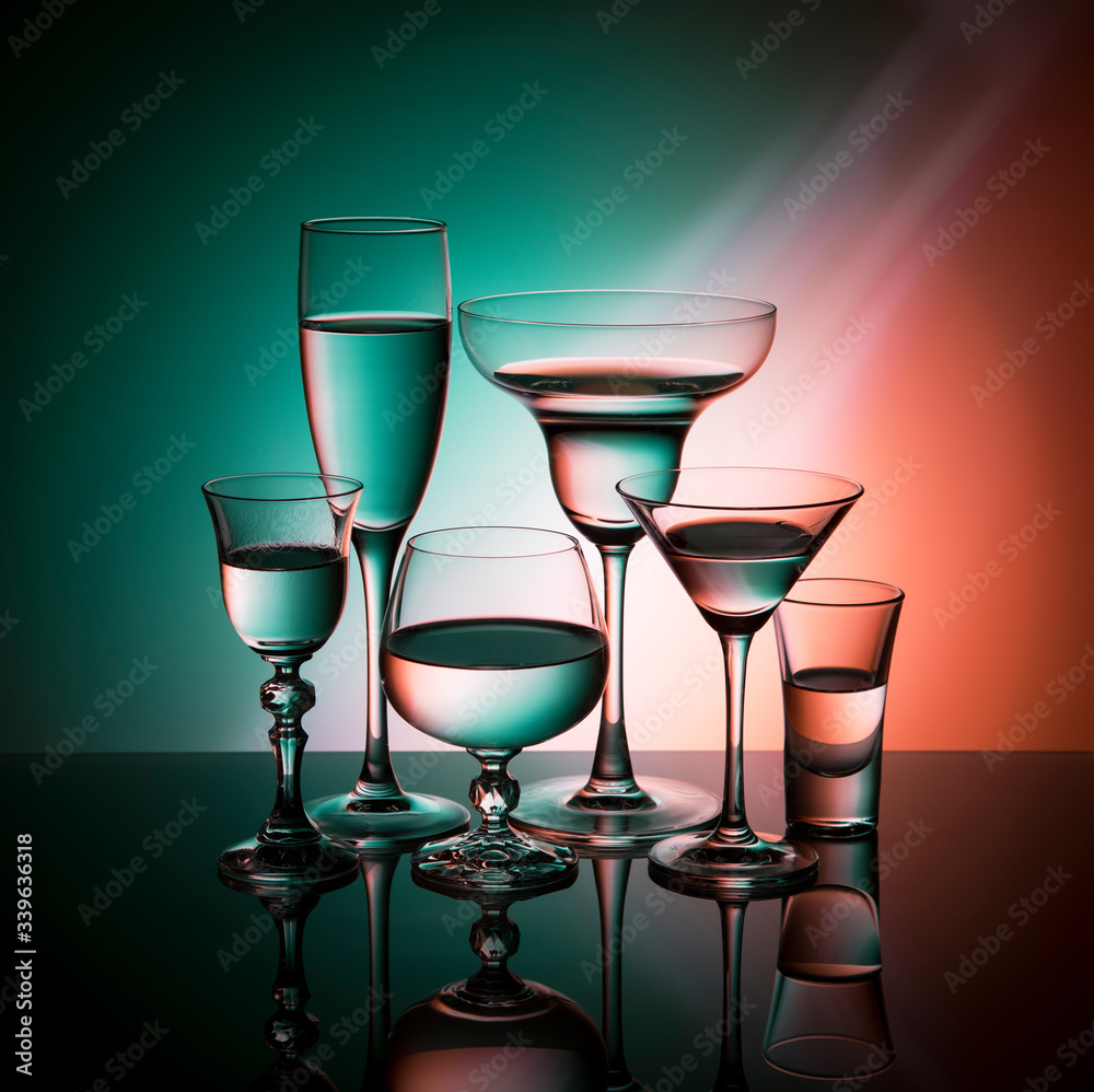 Six glass goblets on color gradient background Six glass goblets on color gradient background