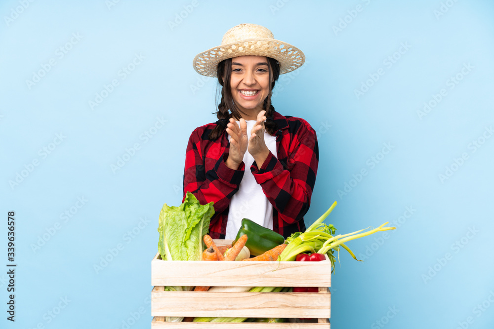 Young farmer Woman holding fresh vegetables in a wooden basket applauding after presentation in a conference