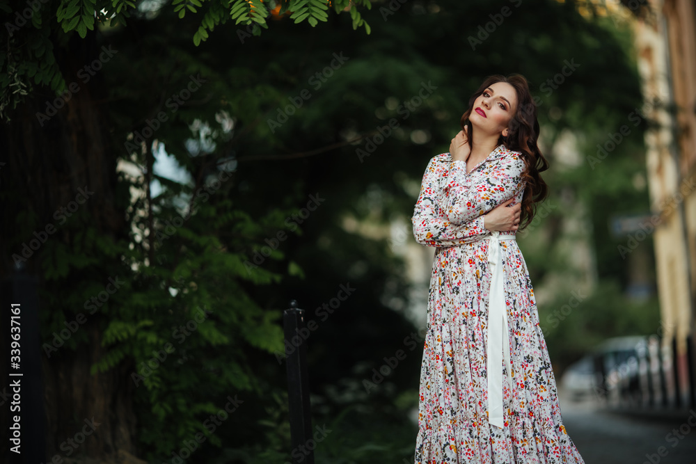 Beautiful girl walking on the street in spring. Young woman enjoying spring weather weather. Beautiful girl walking on the street in spring. Young woman enjoying spring weather weather.
