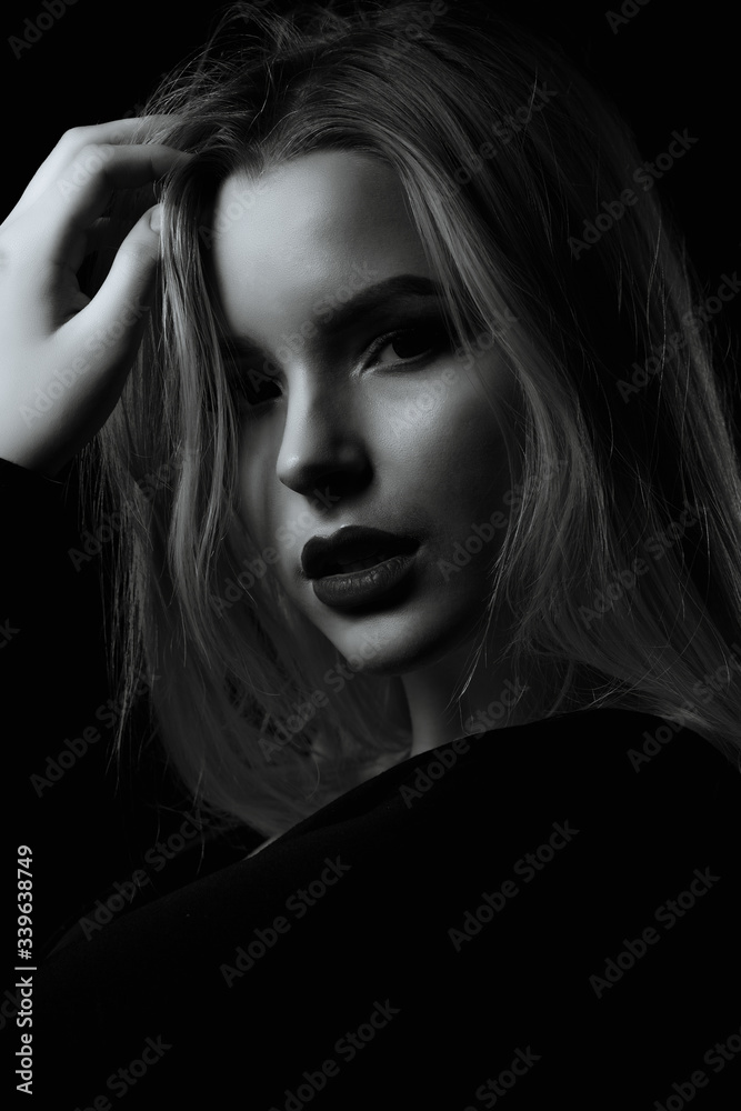 Mysterious girl posing in the dark room