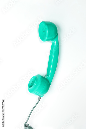 Vintage neo green mint color phone handset on white background.