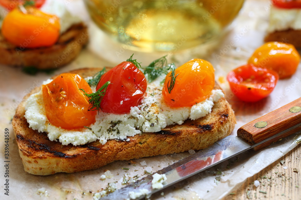Bruschetta with ricotta cheese and sun-dried tomatoes with provencal herbs. Bruschetta with ricotta cheese and sun-dried tomatoes with provencal herbs.
