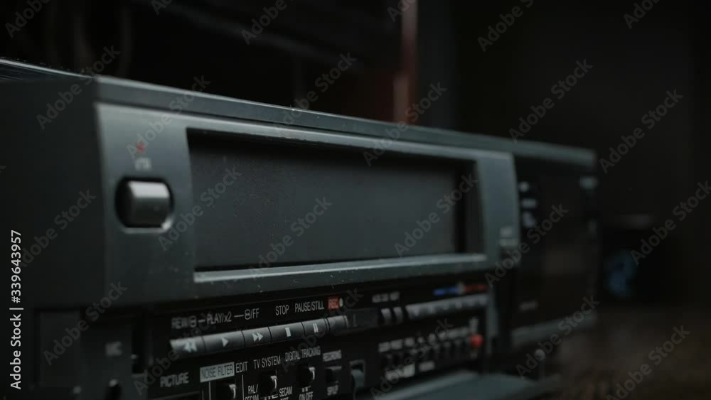 VHS video cassette is loaded and unloaded into the video recorder compartment VHS video cassette is loaded and unloaded into the video recorder compartment