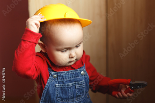 Wallpaper Mural girl with construction tools. Little girl in jeans dress. little girl in a helmet. Child protection and safety. baby building. little girl making repairs Torontodigital.ca