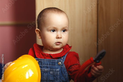 Wallpaper Mural girl with construction tools. Little girl in jeans dress. little girl in a helmet. Child protection and safety. baby building. little girl making repairs Torontodigital.ca