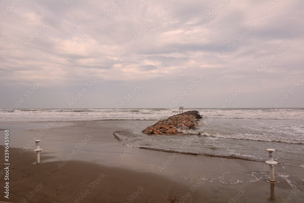 Fototapeta premium Lonely beach with groyne, a stormy day