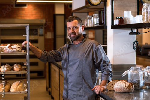 Portrait of mid age male baker at bakery.