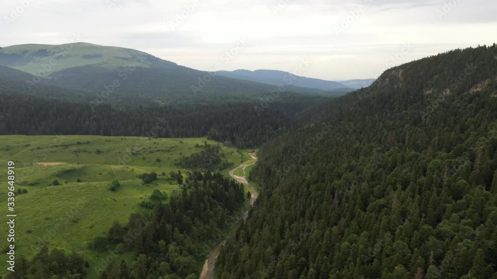 Aerial View, Russia. Adygea mountain. green forest and trees. Green hills and blue sky. Top View. Aerial View, Russia. Adygea mountain. green forest and trees. Green hills and blue sky. Top View.