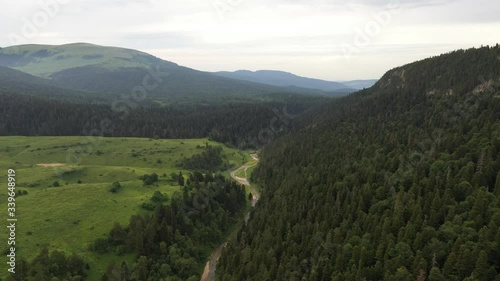 Aerial View, Russia. Adygea mountain. green forest and trees. Green hills and blue sky. Top View.