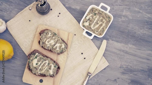 Homemade eggplant and tahini salad spread on a toast or sandwich. Top view composition