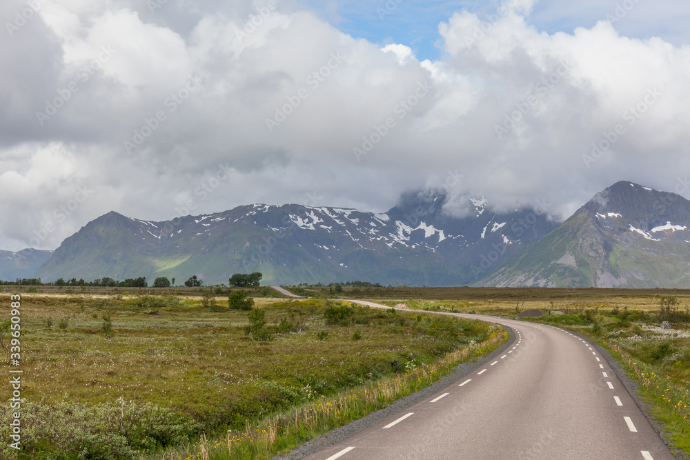 road passing in a valley between mountains in Norway, selective focus road passing in a valley between mountains in Norway, selective focus