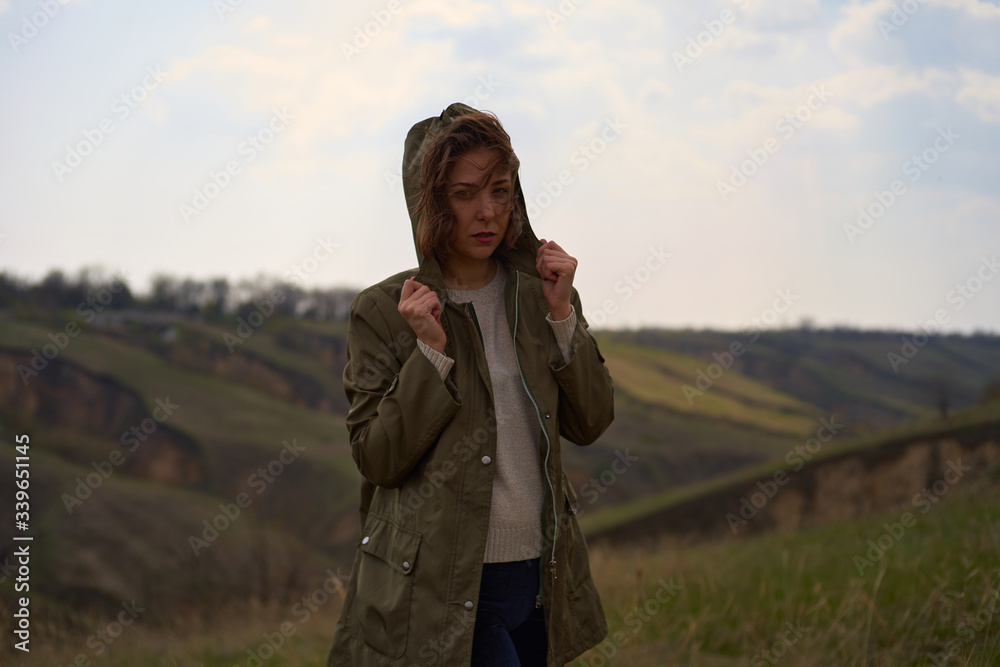 Alone girl on beautiful mountain view feeling free with wind and sky. Isolated woman on nature background, freedom, post apocalypse Alone girl on beautiful mountain view feeling free with wind and sky. Isolated woman on nature background, freedom, post apocalypse
