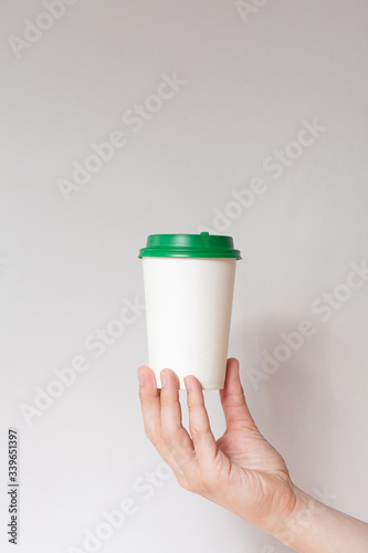Take away coffee cup background. Male hand holding a coffee paper cup