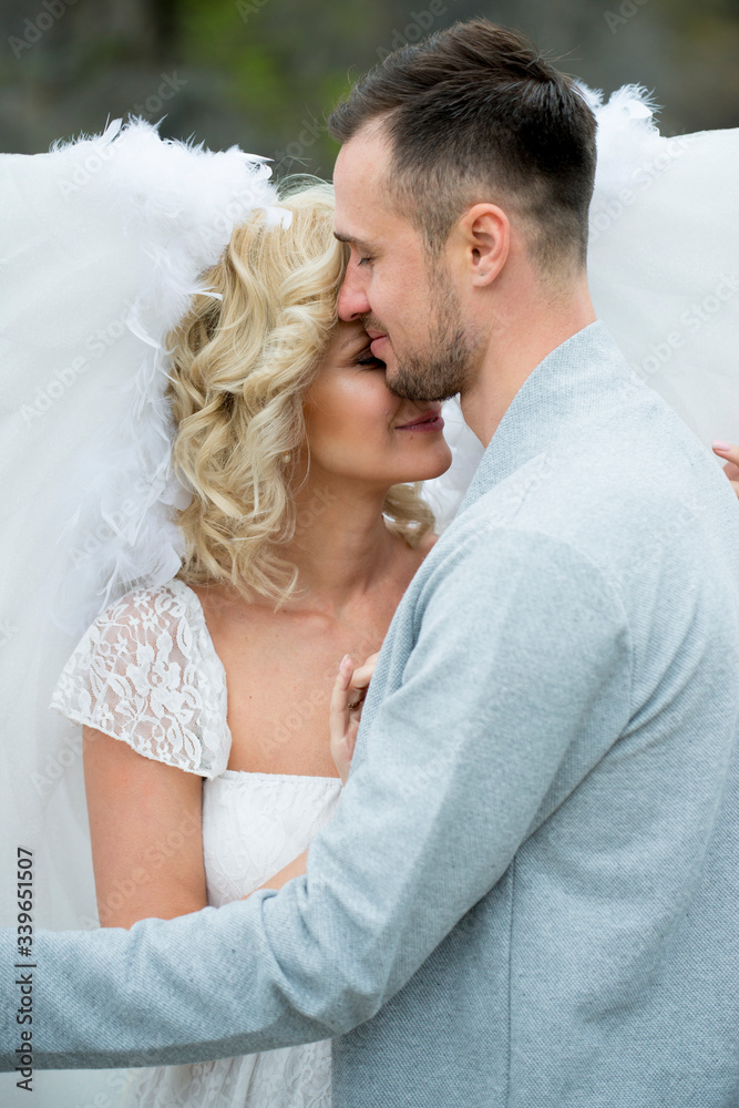 beautiful blonde girl in a white dress hugs a guy beautiful blonde girl in a white dress hugs a guy