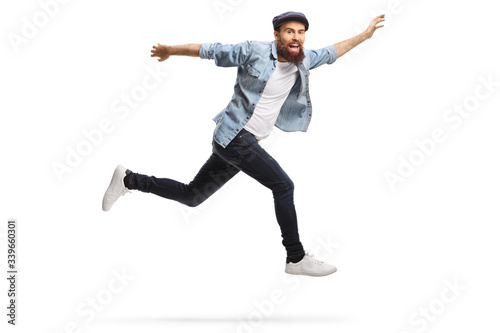 Happy bearded hipster guy in casual clothes jumping