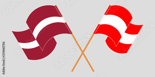 Crossed and waving flags of Latvia and Austria