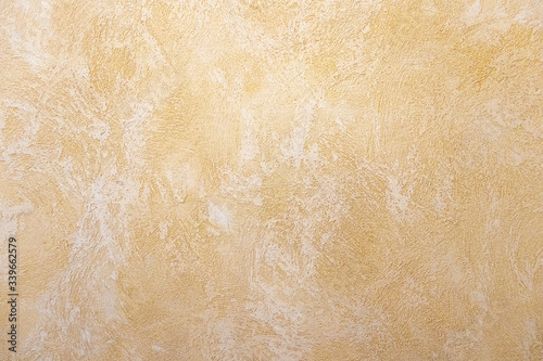 A beige rough plastered wall
