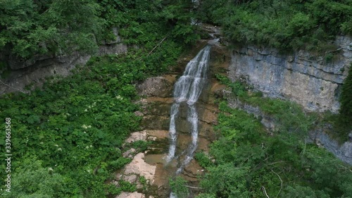 Aerial View, Small waterfall in Adygea mountain, Russia. Top View. Green forest.