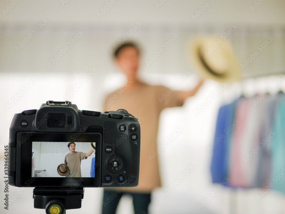 picture on live screen on camera of hat hat was reviewed and recorded on video streaming on camera to sell product by Vlog and blogger online picture on live screen on camera of hat hat was reviewed and recorded on video streaming on camera to sell product by Vlog and blogger online
