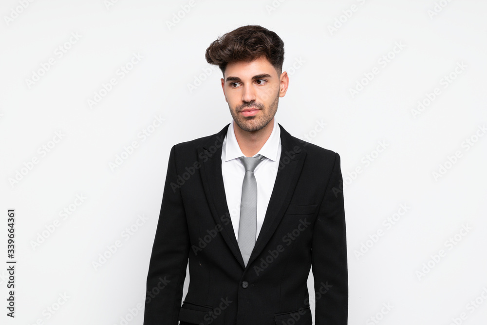 Young businessman over isolated white background standing and looking to the side Young businessman over isolated white background standing and looking to the side