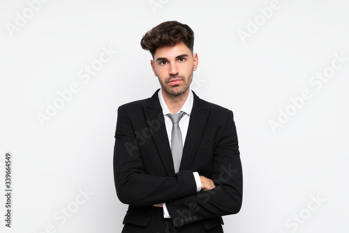Young businessman over isolated white background keeping arms crossed