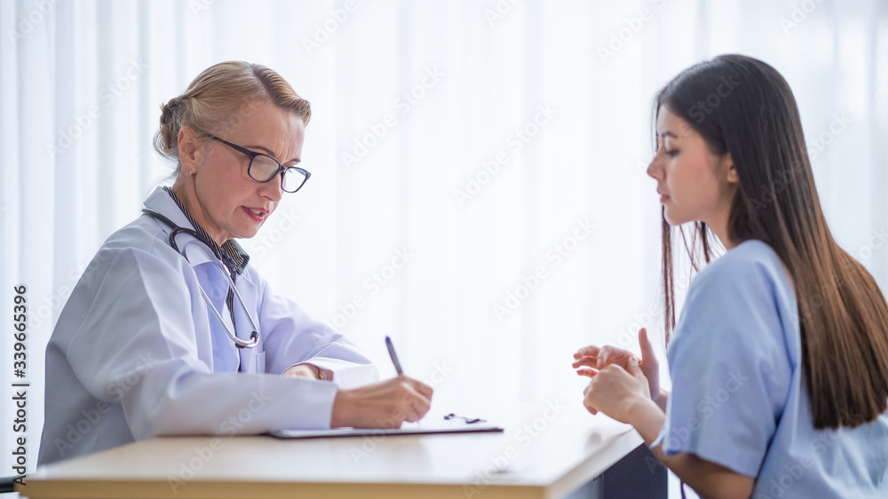 Asian woman patients seeking advice from a doctor Asian woman patients seeking advice from a doctor
