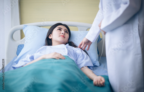 Asian woman patients seeking advice from a doctor on bed