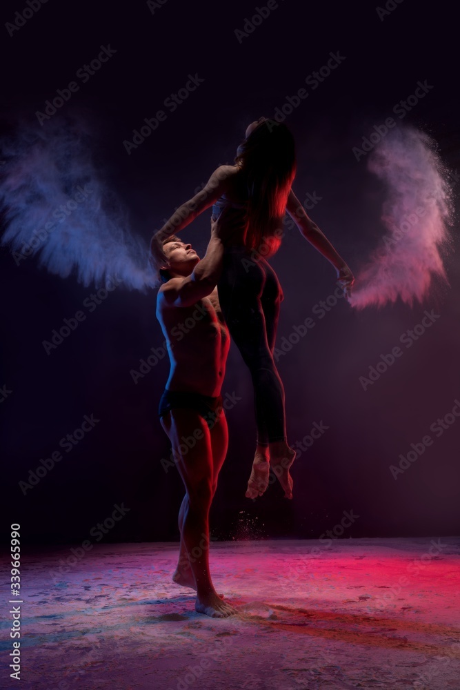 Young couple dancing in white dust cloud view