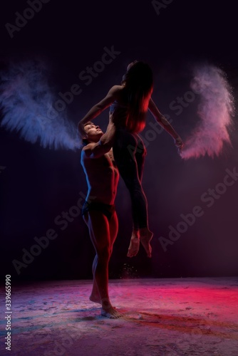 Young couple dancing in white dust cloud view