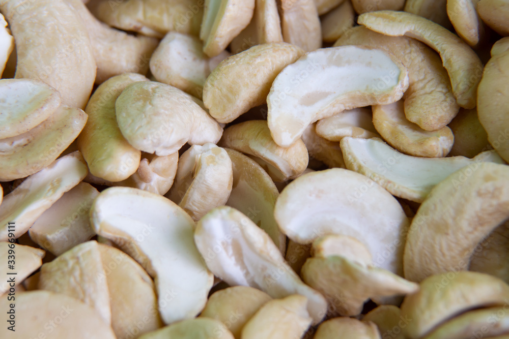 Organic cashews fried without shell on the whole background. macro, macro photography Organic cashews fried without shell on the whole background. macro, macro photography