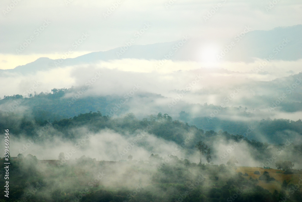 View landscape with silhouettes of mountains range with mist or covered by heavy fog View landscape with silhouettes of mountains range with mist or covered by heavy fog