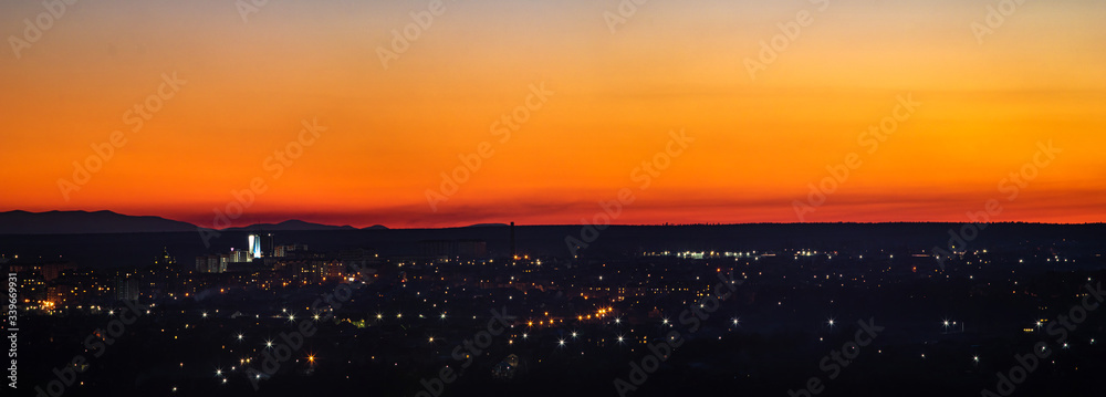 Sunset on the background of the city in spring