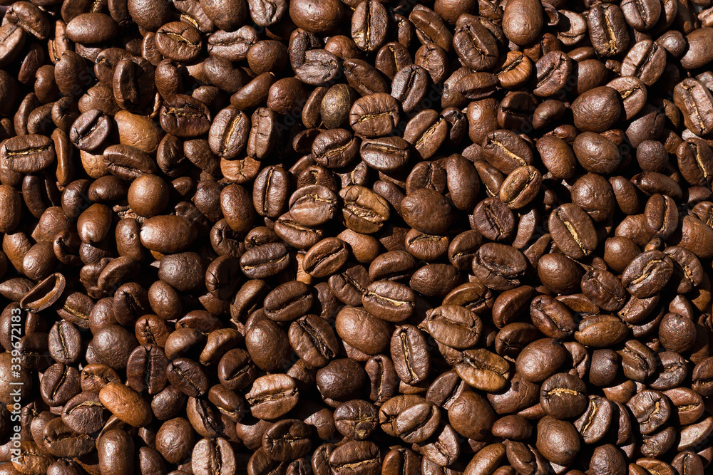 roasted coffee beans are on the table. coffee beans close-up top view roasted coffee beans are on the table. coffee beans close-up top view