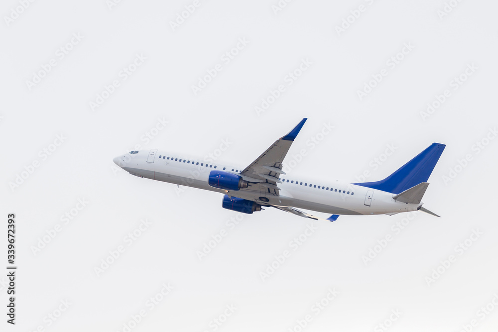 A white passenger plane has taken off on a white background
