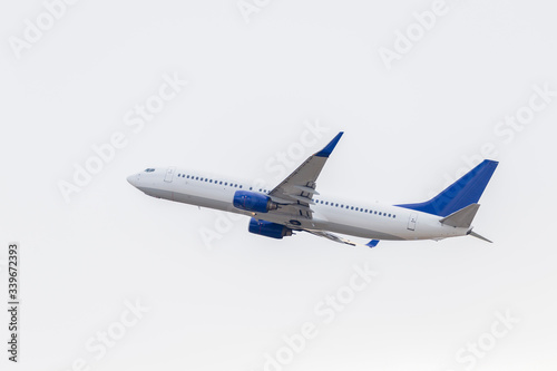 A white passenger plane has taken off on a white background