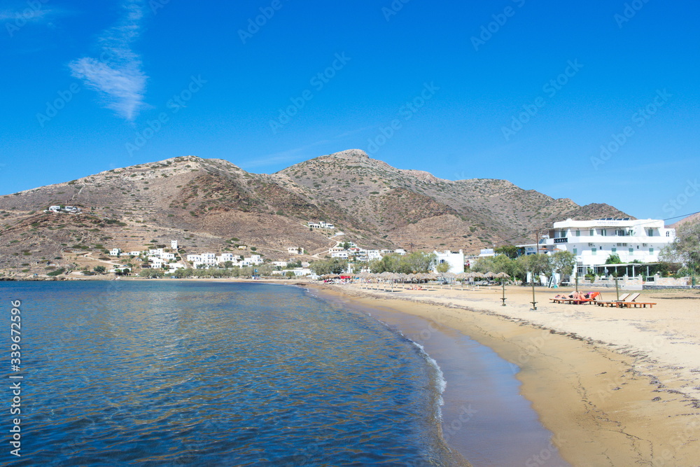The port beach at the Greek island of Ios.  A broad curve of sand at a large, natural harbour.